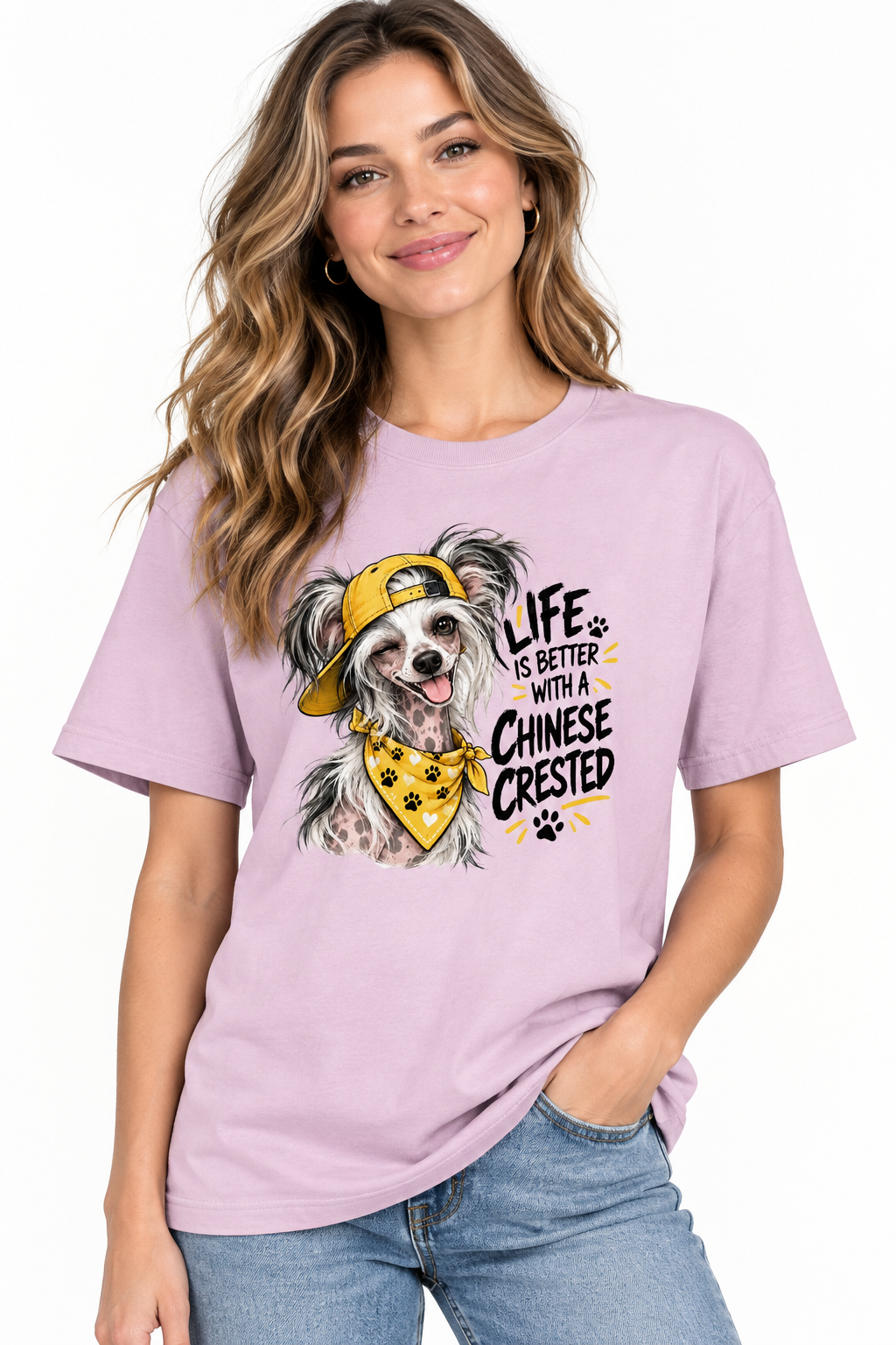 Smiling woman in a lavender shirt with a dog illustration wearing a yellow cap and bandana.